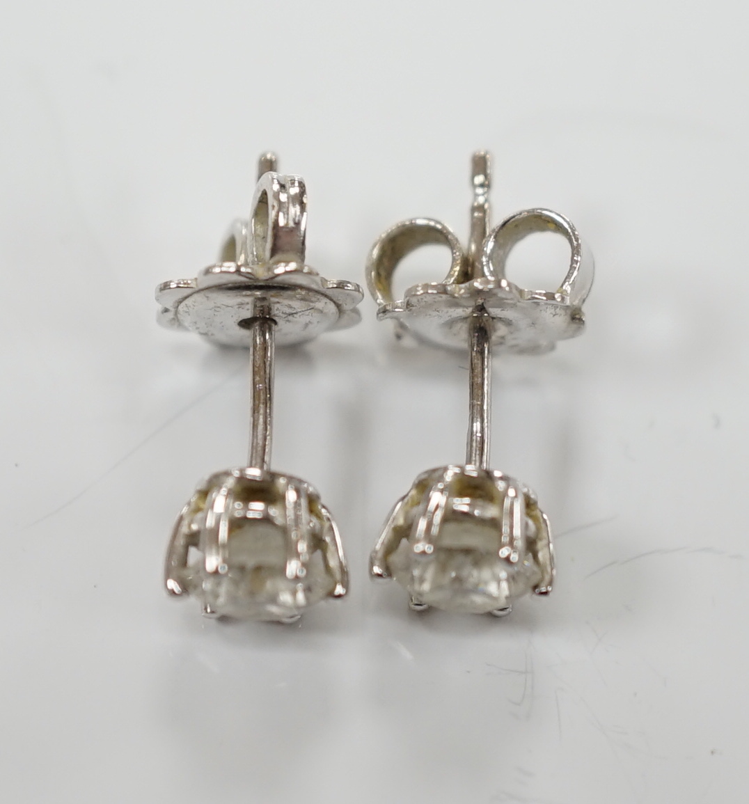 A pair of 18ct white gold and solitaire diamond set ear studs